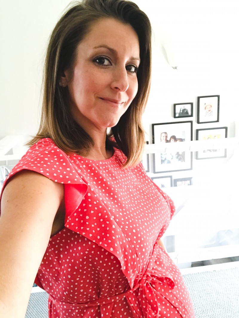 Sarah Fruy wearing a red and white polka dot blouse at home attending DrupalCon 2020