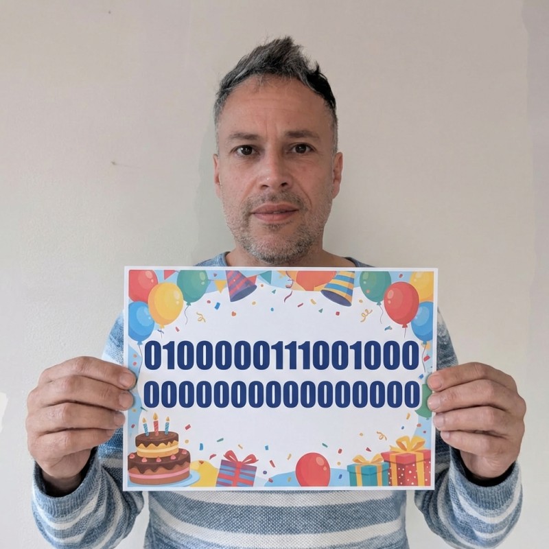 Photo of a person holding a big birthday card with binary numbers