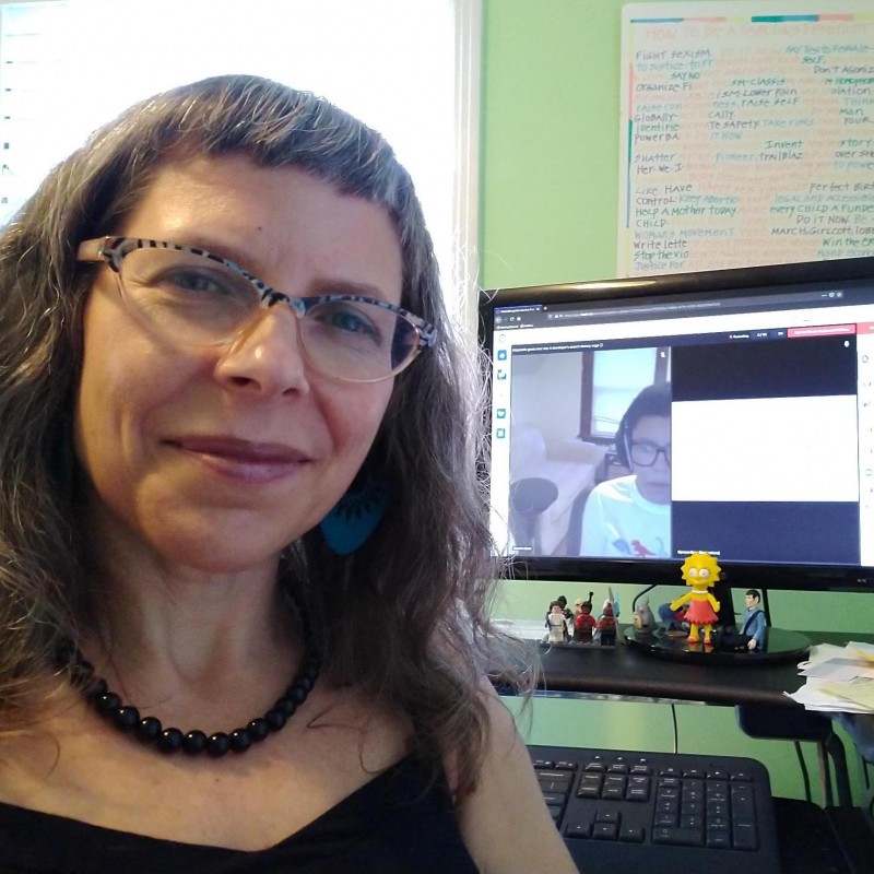 White woman in front of computer screen during Qymana Botts' DrupalCon session
