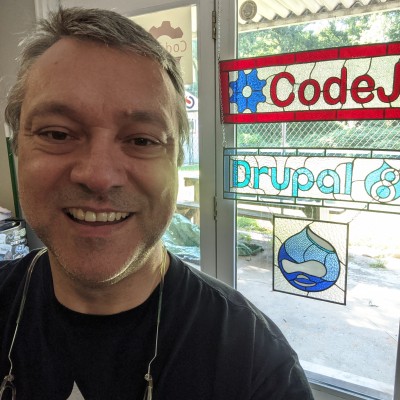 Drupal selfie with Drupal logos in background